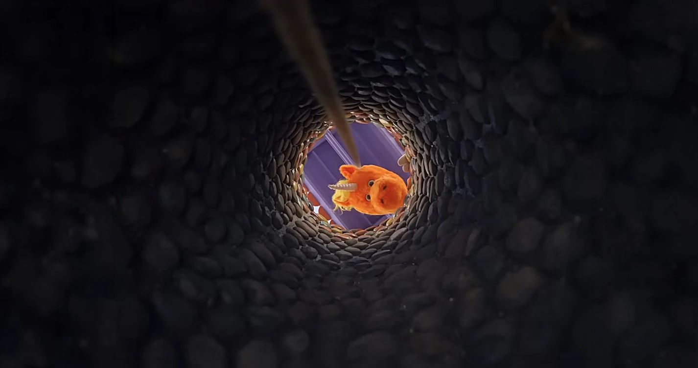 Buddy (2026) — the orange unicorn seen at the bottom of a stone shaft