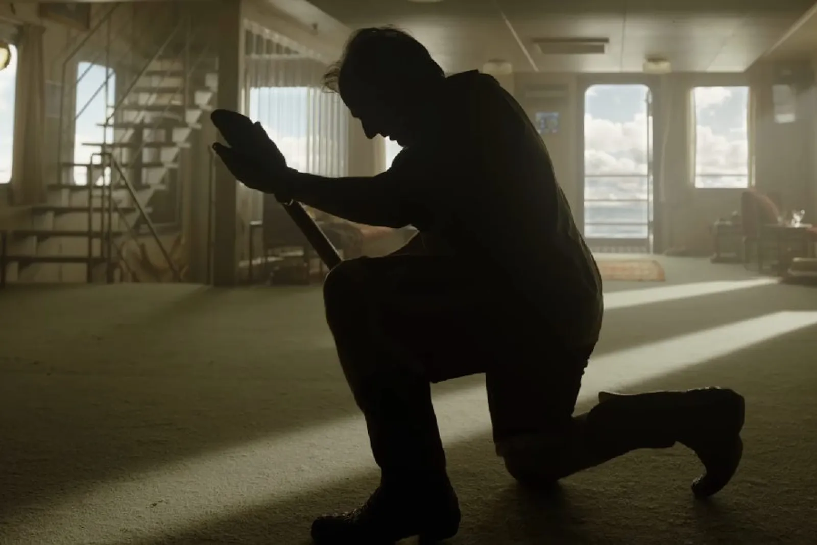 Tom Cruise as Digger Rockwell silhouetted with a shovel in Digger 2026