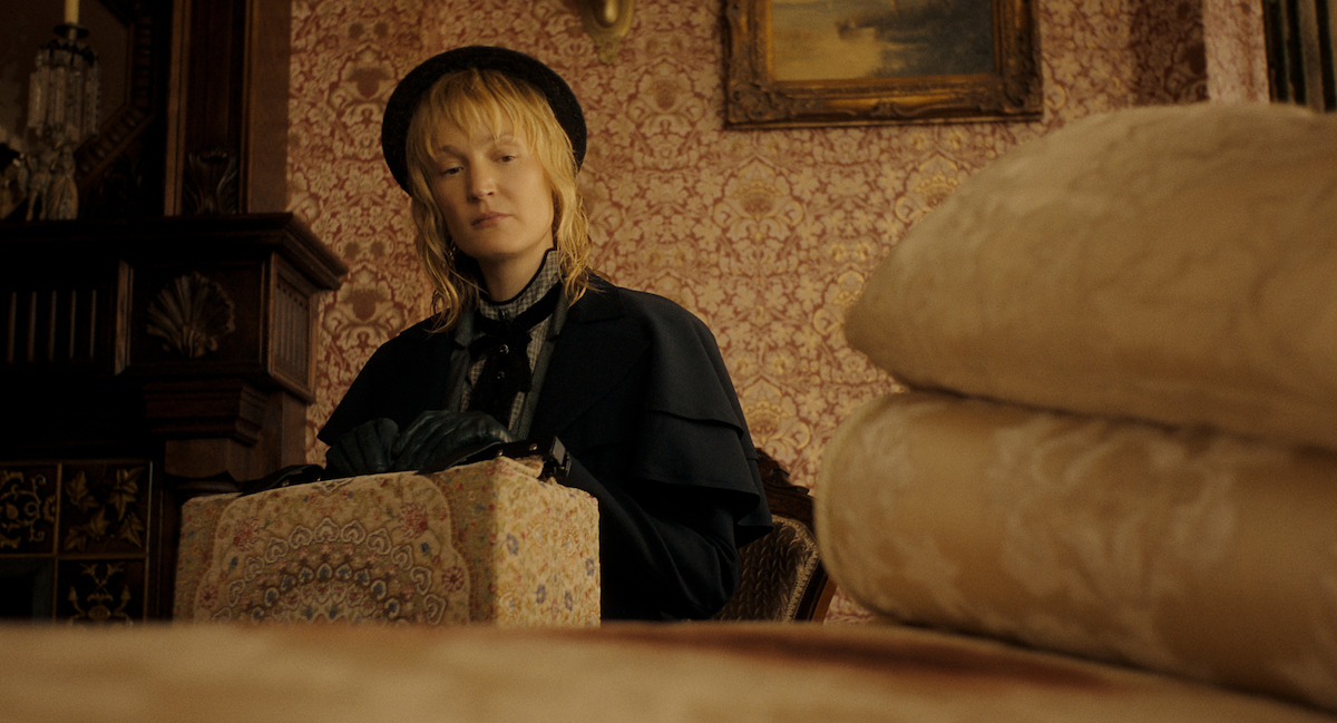 Monster The Lizzie Borden Story 2026 — woman with a patterned box in a Victorian room, Netflix photograph
