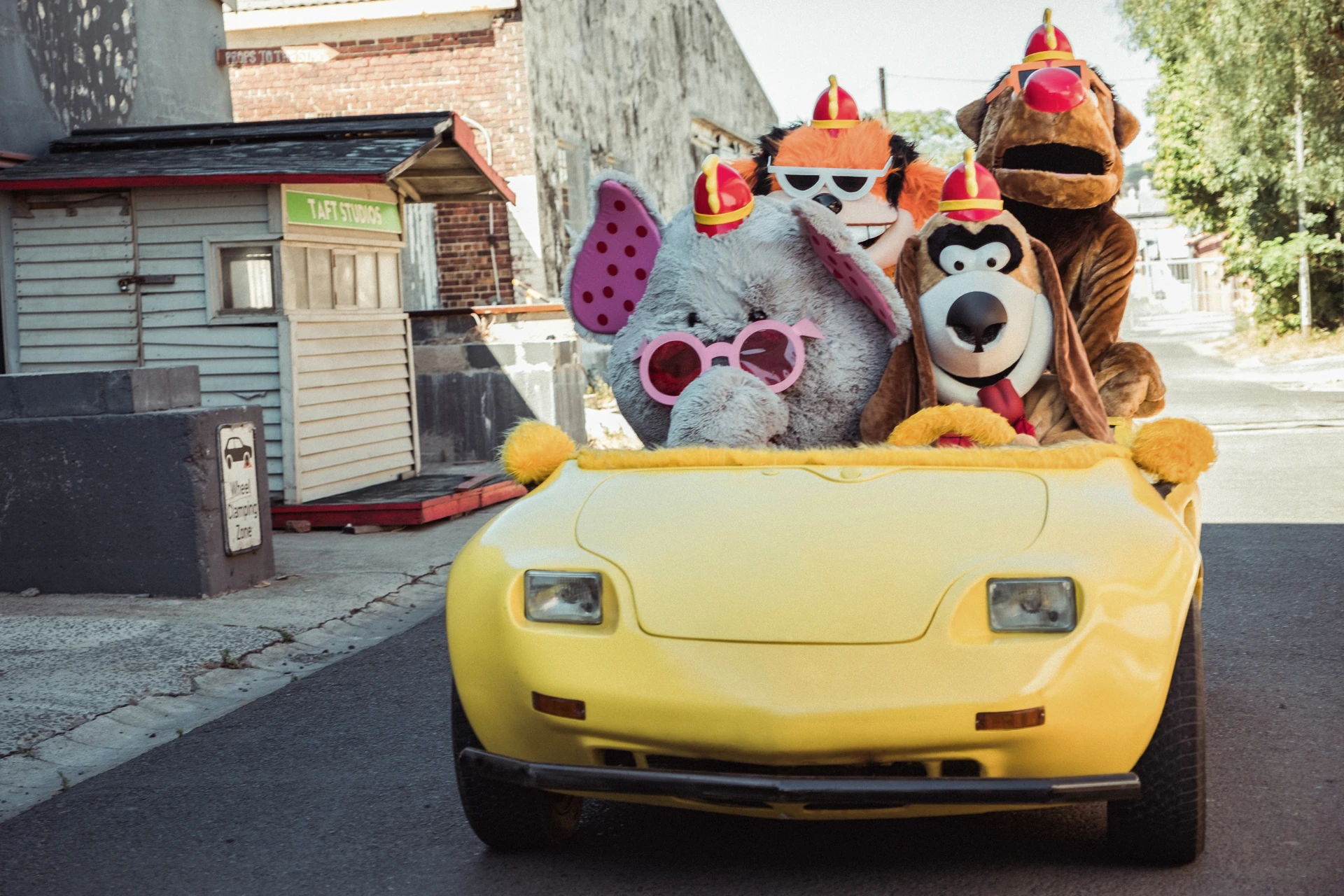 The Banana Splits Movie (2019) — the animal band riding in a yellow vehicle