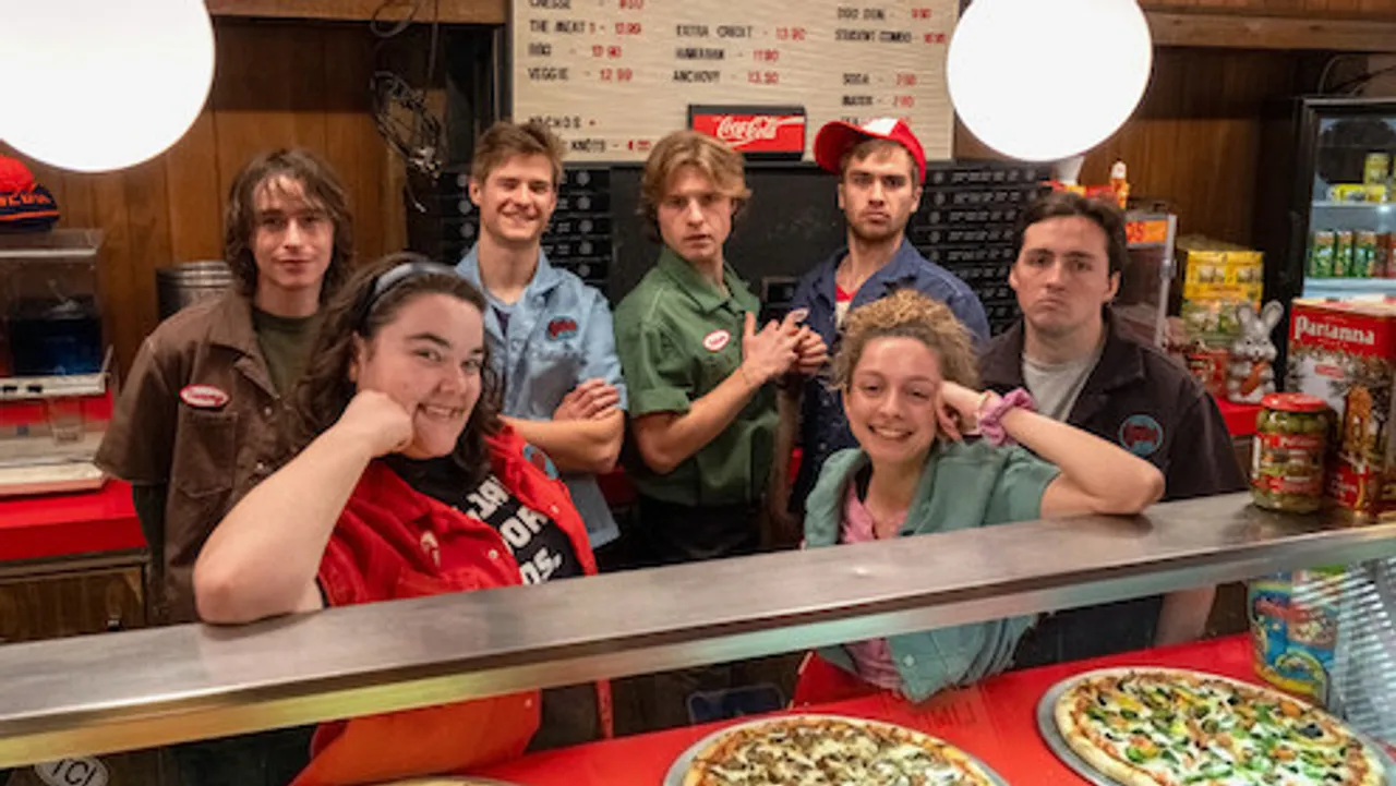 Minimum Wage cast behind the pizzeria counter in the official Netflix first-look image