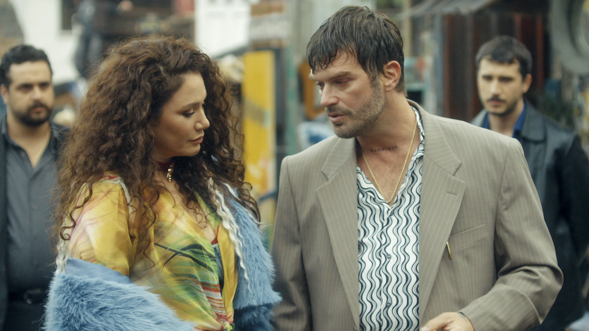 Money Trap: The Karun Treasure official still of two characters talking on a street