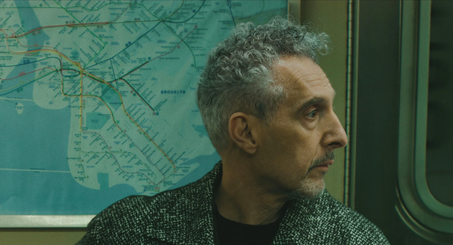 Harry Lehman, played by John Turturro, beside a subway map