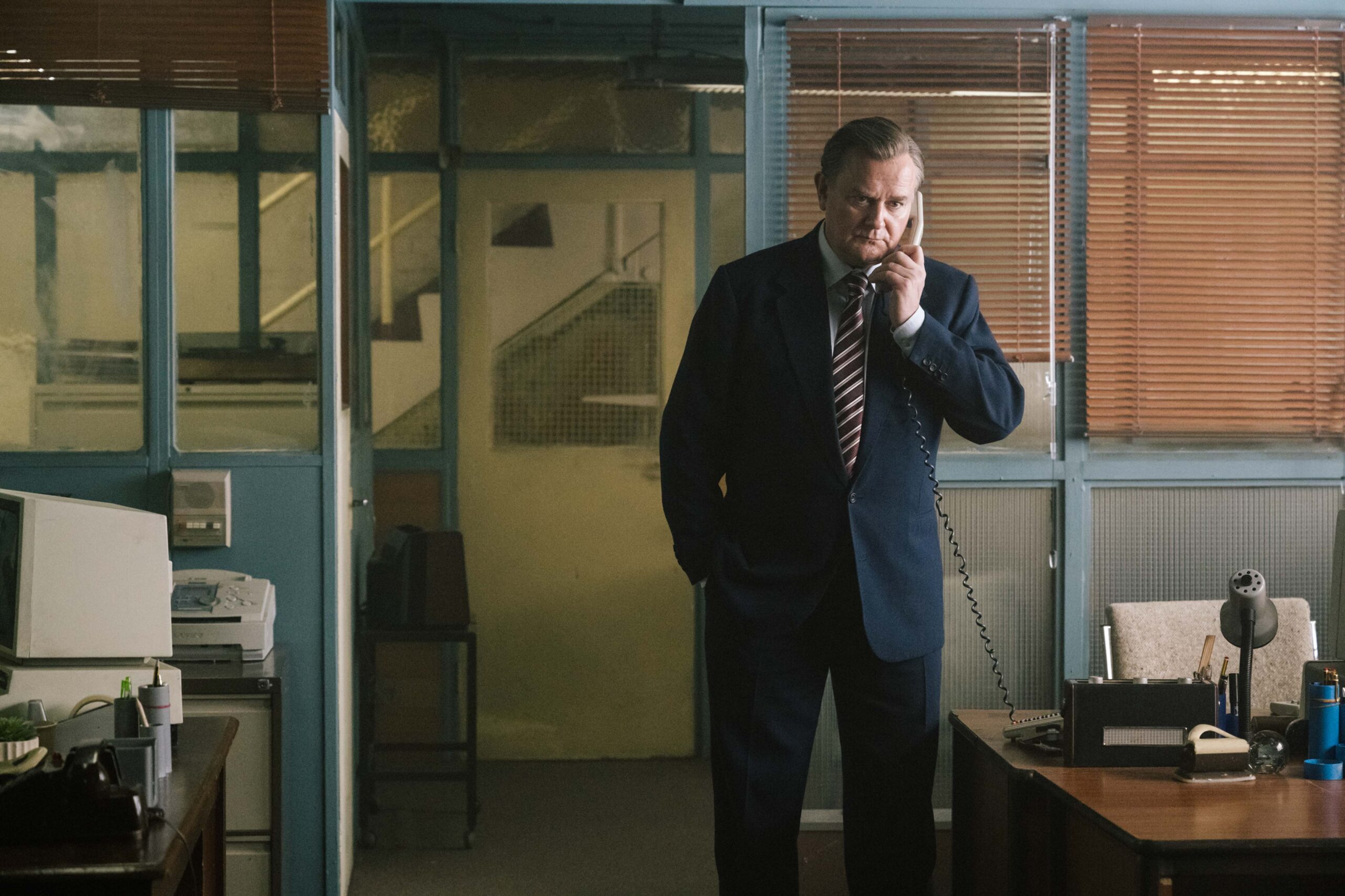 The Gold Season 2 — Hugh Bonneville as Brian Boyce takes a call in the police investigation office