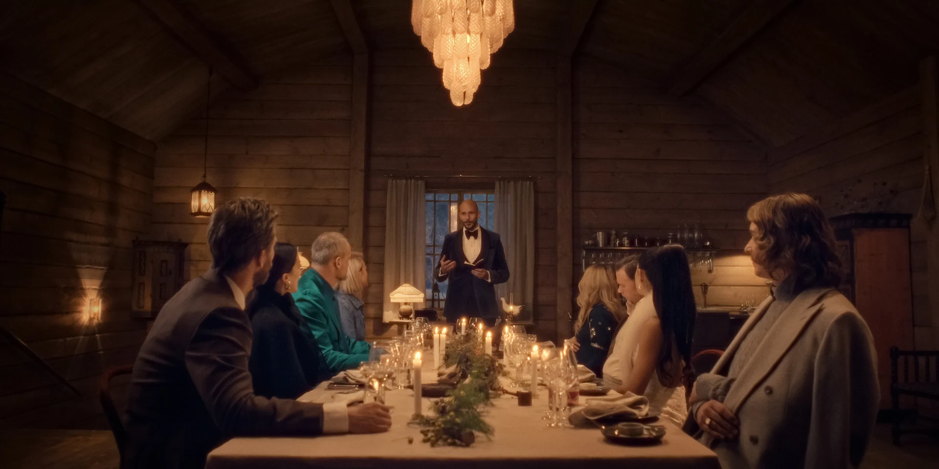 The Storm (2026) — friends seated at a candlelit dinner